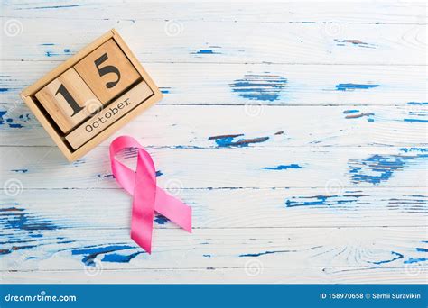 Pink Ribbon And Wooden Cube Calendar Set For October 15 On A Wooden