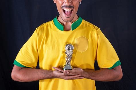 Premium Photo Brazilian Football Black Player Holding Winner Trophy