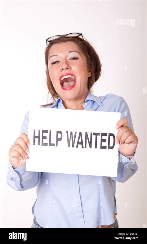 Portrait Of A Young Beautiful Woman Holding A Sign Help Wanted Stock