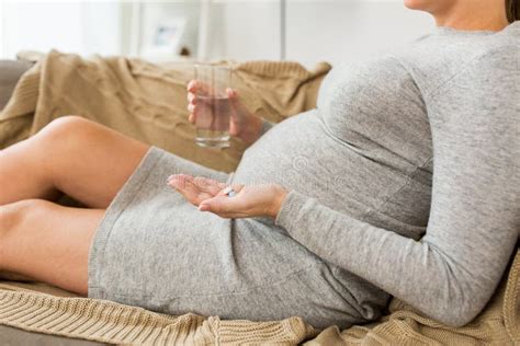 Close Up Of Pregnant Woman With Pills At Home Stock Photo Image Of