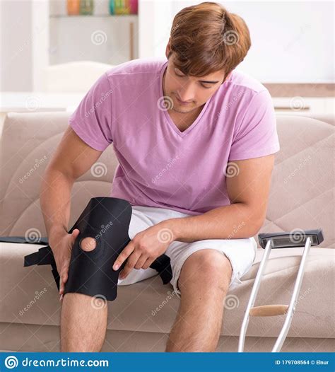 Injured Man Recovering at Home from Sports Injury Stock Photo - Image
