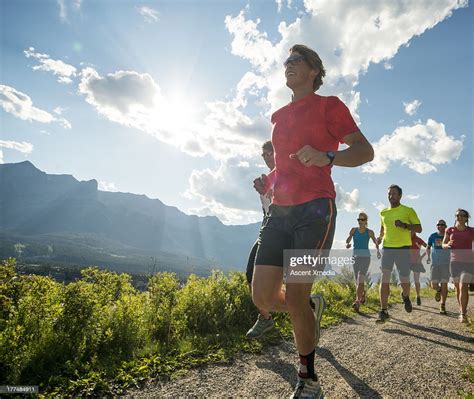 Runners Race Along Path In Mountains High Res Stock Photo Getty Images