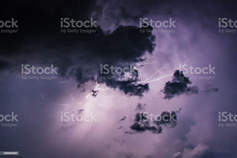 Lightning Bolt Discharges In Purple Storm Clouds At Night Close Stock