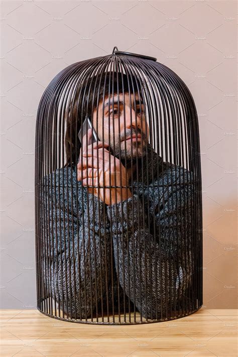 Man Locked In A Cage Featuring Cage Man And Steel People Images