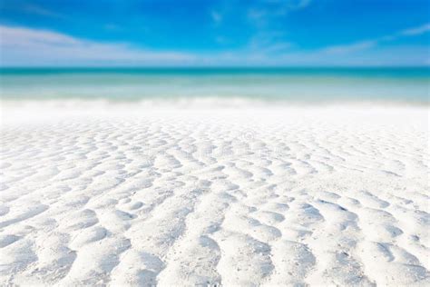 White Sand Curve Or Tropical Sandy Beach With Blurry Blue Ocean And