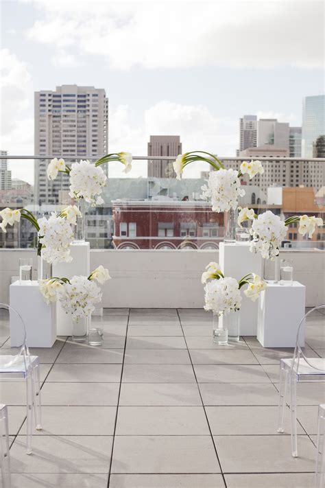 And the tables and chairs that you are going to set, requires an even ground so that they don't topple over. modern ceremony decor with all white flowers and clear ...