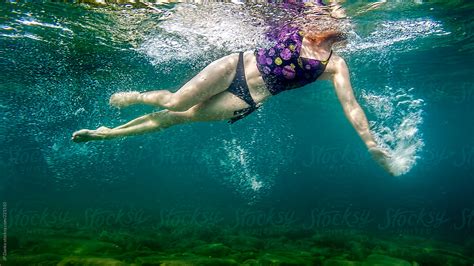 Woman Swimming Underwater In Lake By Stocksy Contributor Jp Danko