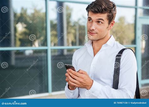 Young Handsome Pensive Businessman Using Mobile Phone Stock Photo