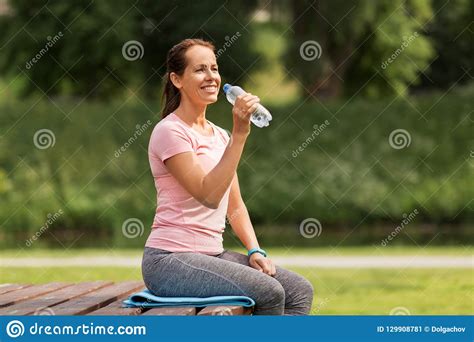 Woman Drinking Water After Exercising In Park Stock Image Image Of