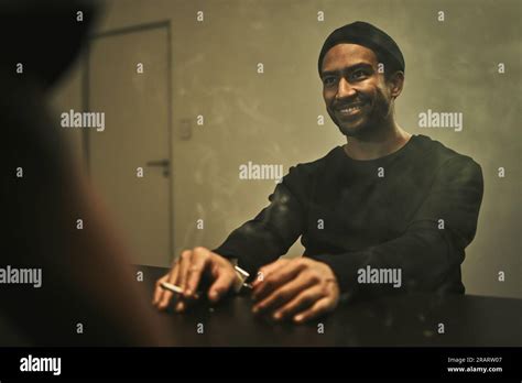 Man, suspect smoking and detective in interrogation room with criminal