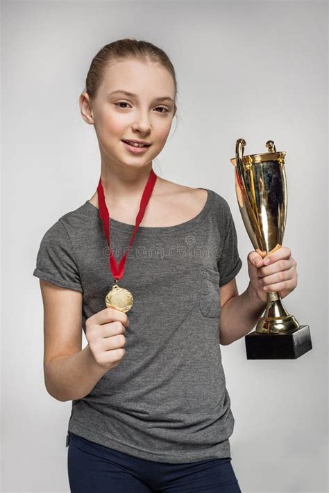 Smiling Girl In Sportswear Holding Trophy And Medal Stock Photo Image