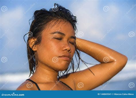 Young Beautiful And Asian Girl In Bikini With Wet Hair Enjoying