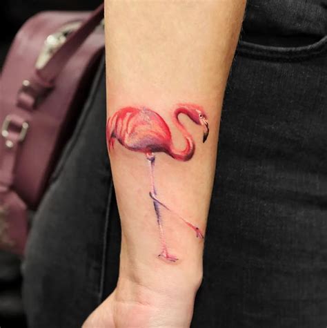 A Pink Flamingo Tattoo On The Left Inner Arm And Wrist Is Shown In
