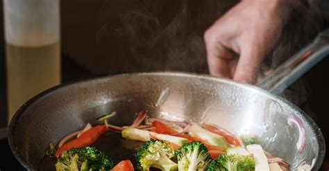 Person Holding Black Cooking Pan With Vegetable Salad · Free Stock Photo
