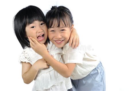 Two Happy Asian Little Sisters Hugging Isolated Stock Image Image Of