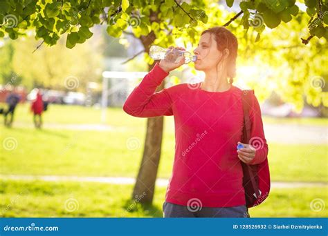 Fitness Girl In Summer Park Drinks Water From Bottle Young Woman In