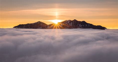 Peaks Of Highland Mountain Range Pictured Poking Through Clouds At