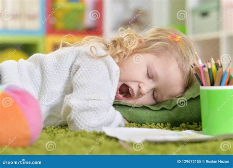 Portrait Of A Cute Little Girl Yawning Stock Image Image Of Floor