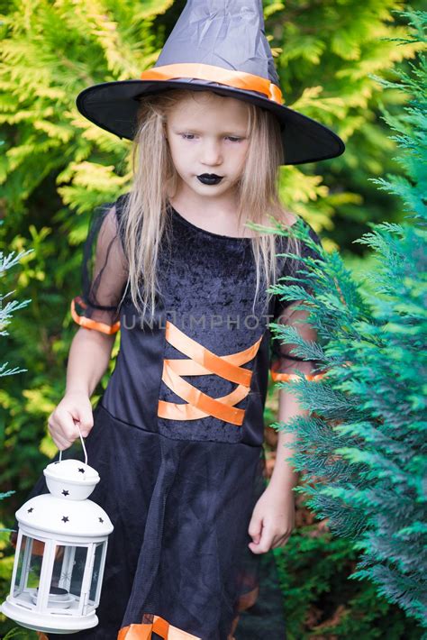 Adorable Amasing Little Girl Wearing Witch Costume On Halloween Trick