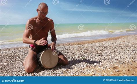 Djembe Traditional Drum Player Beat Rythm On The Lonely Beach Stock
