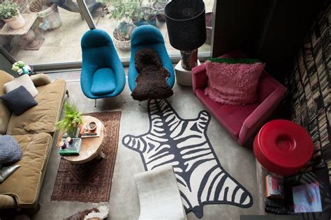 A Living Room Filled With Furniture And A Zebra Print On The Floor Next