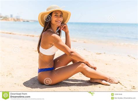 Beautiful Woman With Perfect Body Lying Down On The Beach Wearing