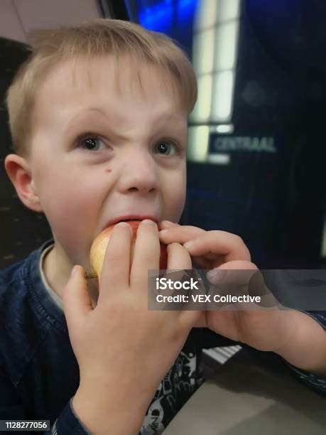 Six Year Old Caucasian Boy Eating An Apple Stock Photo Download Image