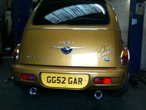 The Back End Of A Gold Car Parked In A Garage
