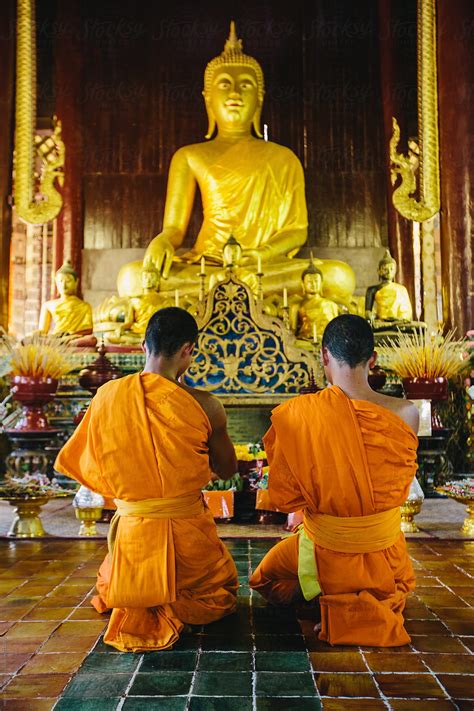 Two Buddhist Monks Praying In The Temple By Stocksy Contributor