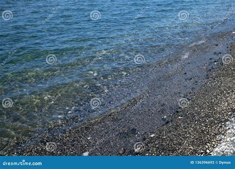 Landscape With Clear Calm Sea Waves Near Stone Seacoast Stock Photo