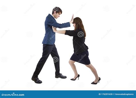 Businessman And Businesswoman Pushing Each Other Away Stock Photo