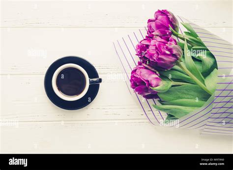 Cup Of Morning Coffee And Bouquet Of Spring Flowers Tulips Over White