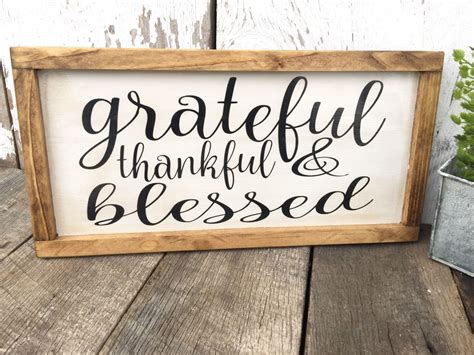 A Wooden Sign That Says Grateful Thank And Blessed On It Next To A