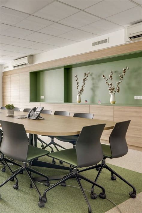 An Empty Conference Room With Green Carpeting And Wooden Paneled Wall