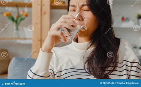 Sick Young Asia Woman Holding Pill Glass Of Water Take Medicine Sit On Couch At Home Girl