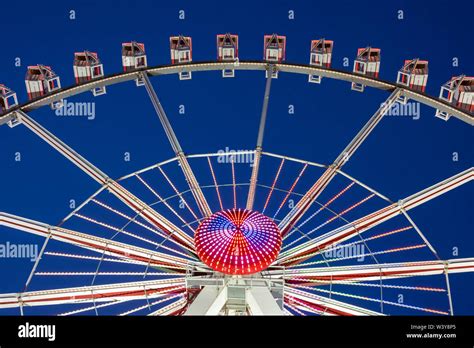 Illuminated Ferris Wheel At Hamburger Dom Funfair At Night St Pauli