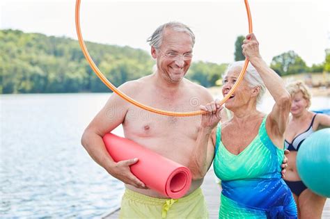 Senior Couple Fooling Around With A Tire Stock Image Image Of People