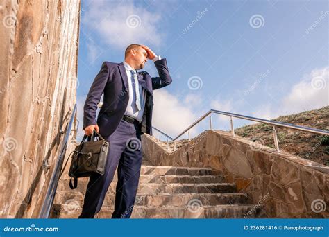 Confident Middle Age Businessman With Briefcase Walking Upstairs Close