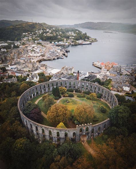 An Aerial View Of A Circular Building In The Middle Of A Town With