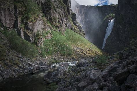 Hiking To Voringsfossen Waterfall In A Valley At Hardangervidda