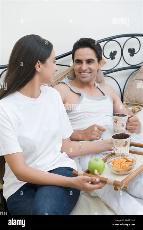 Smiling Couple Having Breakfast On Bed At Home Couple Hi Res Stock