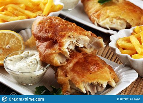 Traditional British Fish And Chips Consisting Of Fried Fish Pot Stock