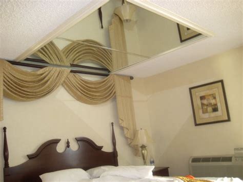 Small pic over bed, then mirrors over the nightstands, behind the lamps. Mirror over bed in "Luv Tub" King Suite - Yelp