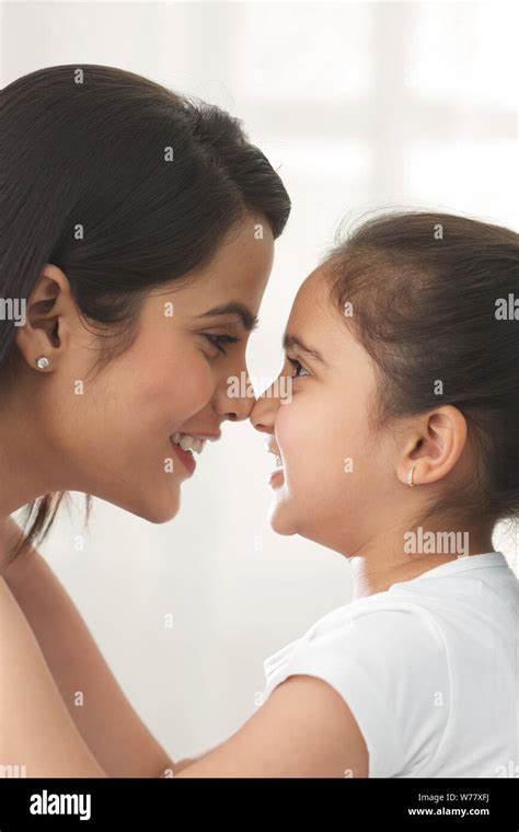 Woman And Her Daughter Rubbing Their Noses Together Stock Photo Alamy