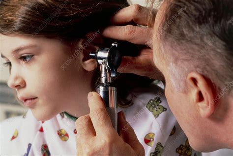 Doctor Using Otoscope To Examine Ear Of Young Girl Stock Image M825