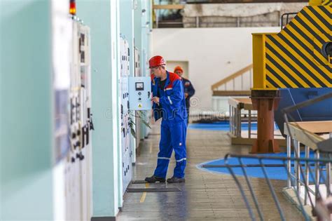 Employees Of The Zeya Hydroelectric Station Are In The Engine Room And Discuss Their Work On The