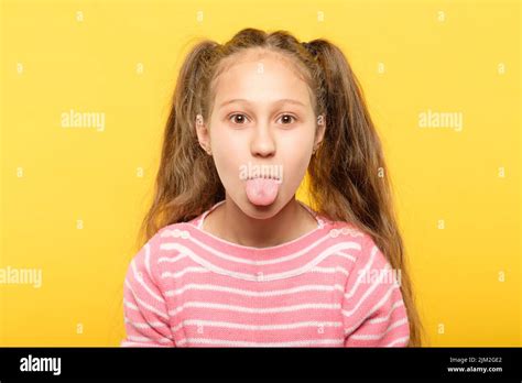 Girl Sticking Tongue Out Cute Antics Frolicking Stock Photo Alamy