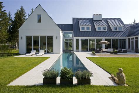 Metal roof colors influence the energy of a building, so careful selection can ultimately save money on energy bills. Rear elevation of contemporary European farmhouse in white ...