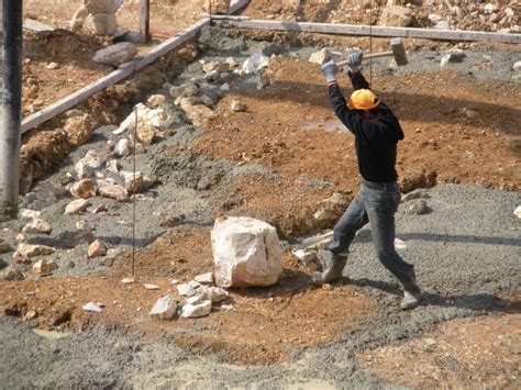 Syrian Worker In Lebanon Splitting Rocks At A Construction Site