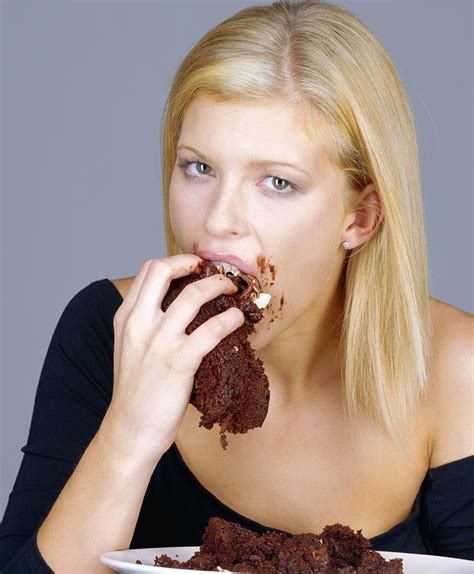 woman eating cake photograph by jason kelvin science photo libray
